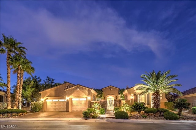 5162 Estasi St, Las Vegas, NV 89135 - mediterranean / spanish home with stucco siding, an attached garage, and driveway