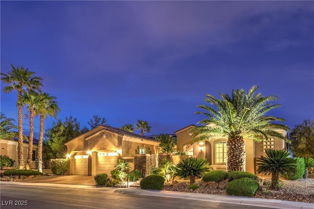 5162 Estasi St, Las Vegas, NV 89135 - mediterranean / spanish home featuring an attached garage, concrete driveway, stucco siding, and a gate