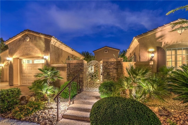 5162 Estasi St, Las Vegas, NV 89135 - view of front of house featuring a garage, a gate, and stucco siding
