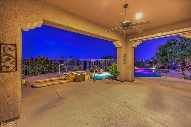5162 Estasi St, Las Vegas, NV 89135 - patio at night with a ceiling fan and a patio area