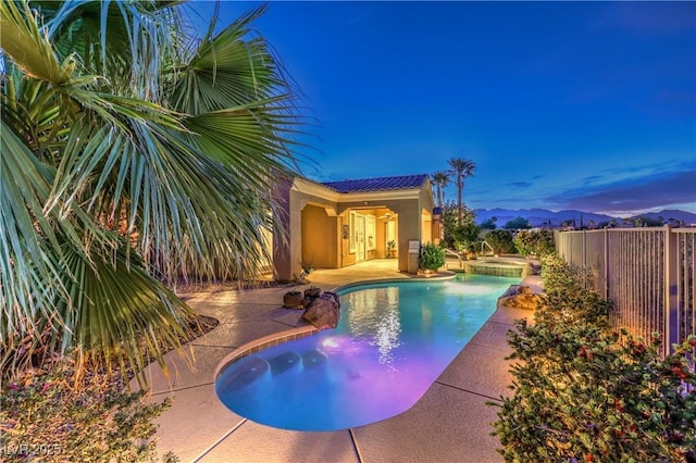 5162 Estasi St, Las Vegas, NV 89135 - view of swimming pool featuring a fenced backyard, a patio area, a pool with connected hot tub, and a mountain view