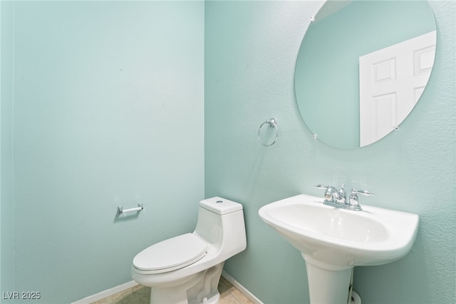 2482 Denholme St, Henderson, NV 89044 - half bathroom featuring toilet, tile patterned floors, and baseboards