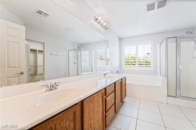 2482 Denholme St, Henderson, NV 89044 - bathroom with a shower stall, a garden tub, double vanity, and tile patterned floors