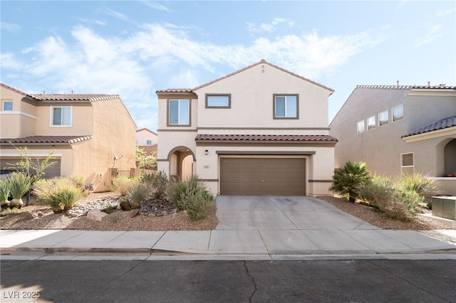 2482 Denholme St, Henderson, NV 89044 - mediterranean / spanish-style home featuring stucco siding, driveway, an attached garage, and a tiled roof