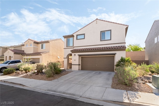 2482 Denholme St, Henderson, NV 89044 - mediterranean / spanish-style house with a garage, stucco siding, concrete driveway, and a tiled roof