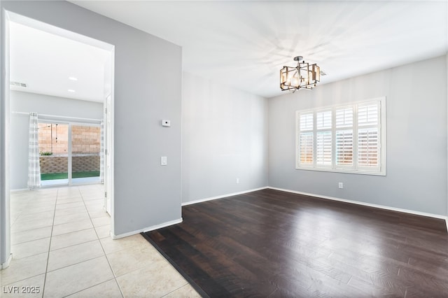 2482 Denholme St, Henderson, NV 89044 - unfurnished room with plenty of natural light, a chandelier, baseboards, and wood finished floors