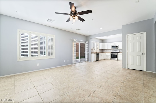 2482 Denholme St, Henderson, NV 89044 - unfurnished living room featuring ceiling fan, light tile patterned flooring, baseboards, and recessed lighting