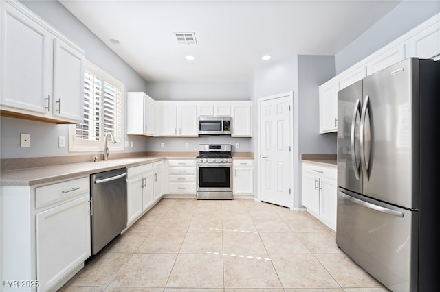2482 Denholme St, Henderson, NV 89044 - kitchen featuring stainless steel appliances, a sink, white cabinetry, and recessed lighting
