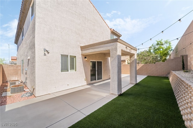 2482 Denholme St, Henderson, NV 89044 - back of property featuring stucco siding, a patio, and central AC unit