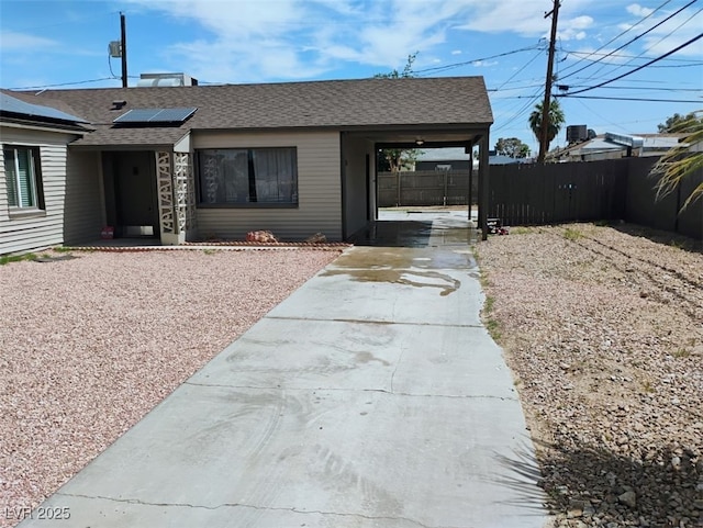 4525 Fulton Pl, Las Vegas, NV 89107 - view of front of house with concrete driveway, roof with shingles, and roof mounted solar panels