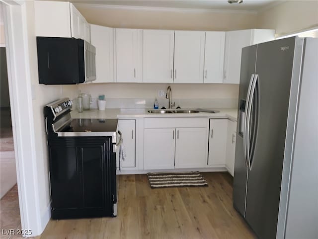 4525 Fulton Pl, Las Vegas, NV 89107 - kitchen featuring black appliances, a sink, light wood-style floors, white cabinetry, and light countertops