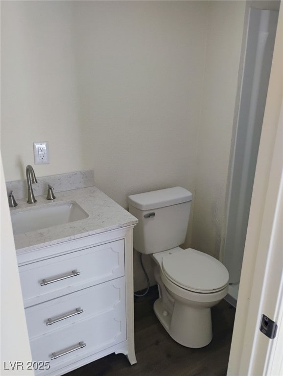 4525 Fulton Pl, Las Vegas, NV 89107 - bathroom featuring toilet, vanity, and wood finished floors