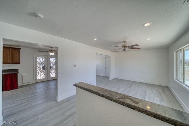 1190 W Sierra Vista Cir, Pahrump, NV 89060 - unfurnished living room featuring light wood finished floors, a ceiling fan, french doors, baseboards, and recessed lighting