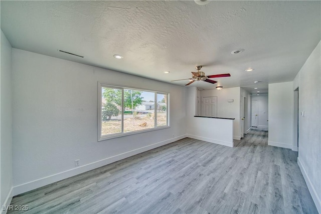 1190 W Sierra Vista Cir, Pahrump, NV 89060 - unfurnished living room featuring baseboards, wood finished floors, a ceiling fan, recessed lighting, and a textured ceiling