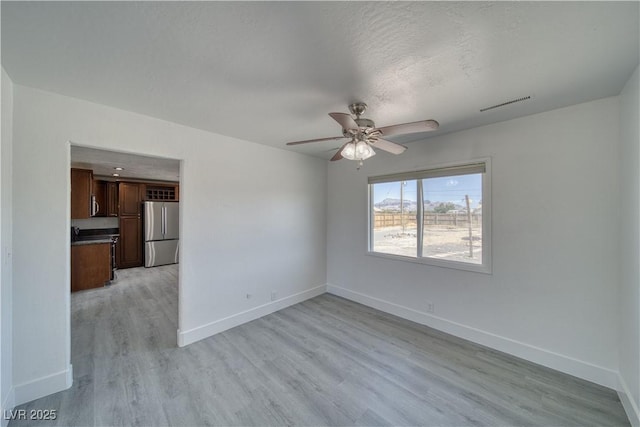 1190 W Sierra Vista Cir, Pahrump, NV 89060 - unfurnished room with light wood-style floors, baseboards, and a ceiling fan
