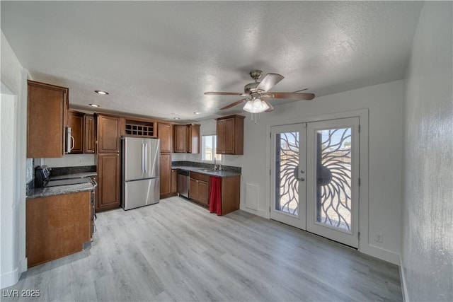 1190 W Sierra Vista Cir, Pahrump, NV 89060 - kitchen featuring stainless steel appliances, a sink, dark countertops, french doors, and ceiling fan