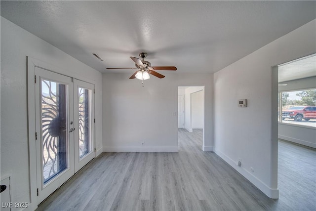 1190 W Sierra Vista Cir, Pahrump, NV 89060 - unfurnished room featuring light wood-style floors, ceiling fan, baseboards, and french doors