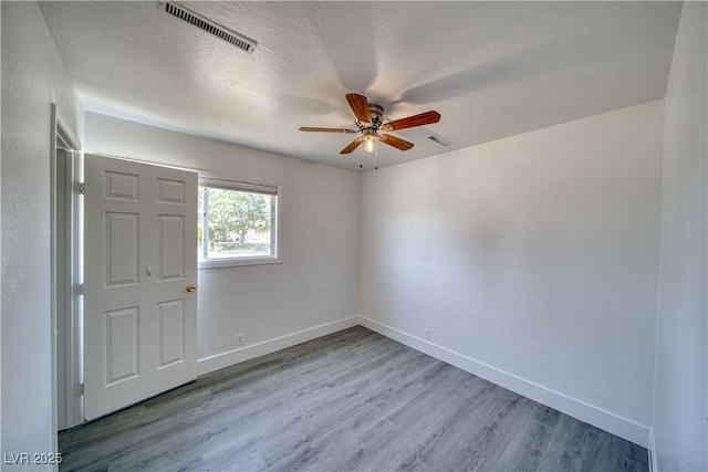 1190 W Sierra Vista Cir, Pahrump, NV 89060 - unfurnished room with ceiling fan, wood finished floors, and baseboards