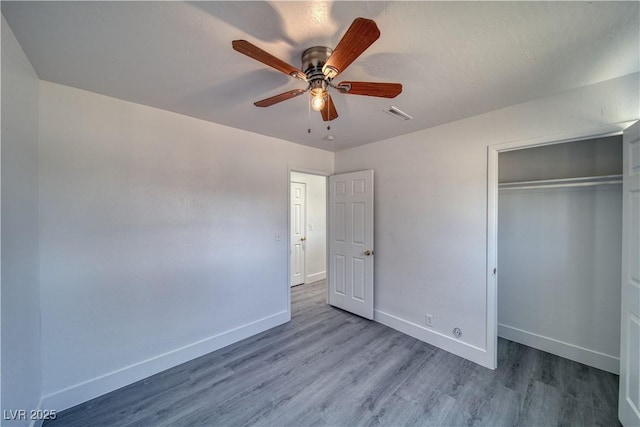 1190 W Sierra Vista Cir, Pahrump, NV 89060 - unfurnished bedroom featuring wood finished floors, baseboards, and a closet