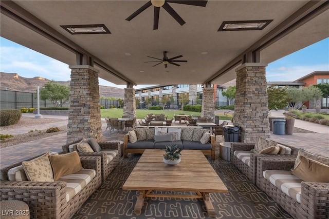 6700 Regency Stone Way, Las Vegas, NV 89148 - view of patio featuring an outdoor living space, a ceiling fan, a mountain view, and outdoor dining space