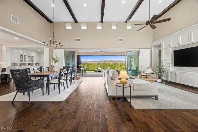 6700 Regency Stone Way, Las Vegas, NV 89148 - living room with a high ceiling, a ceiling fan, beamed ceiling, dark wood-style floors, and a chandelier