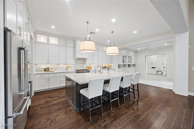 6700 Regency Stone Way, Las Vegas, NV 89148 - kitchen featuring high quality fridge, white cabinets, dark wood-type flooring, tasteful backsplash, and glass insert cabinets