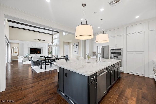 6700 Regency Stone Way, Las Vegas, NV 89148 - kitchen featuring a sink, stainless steel appliances, pendant lighting, dark wood-style floors, and open floor plan
