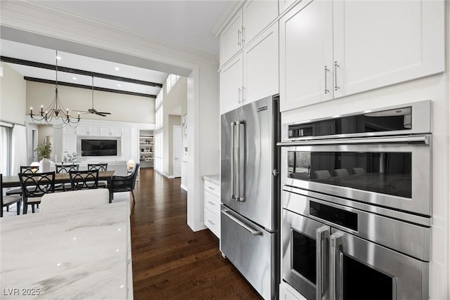 6700 Regency Stone Way, Las Vegas, NV 89148 - kitchen featuring stainless steel appliances, a chandelier, dark wood-style flooring, white cabinetry, and light stone countertops