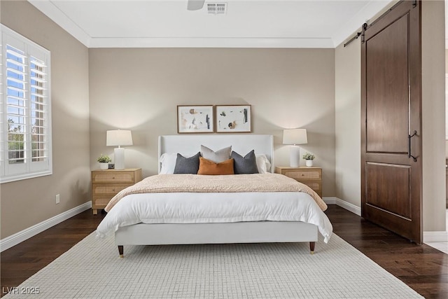 6700 Regency Stone Way, Las Vegas, NV 89148 - bedroom with dark wood finished floors, baseboards, ornamental molding, and a barn door
