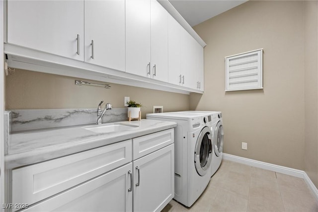 6700 Regency Stone Way, Las Vegas, NV 89148 - washroom with cabinet space, baseboards, separate washer and dryer, and light tile patterned floors