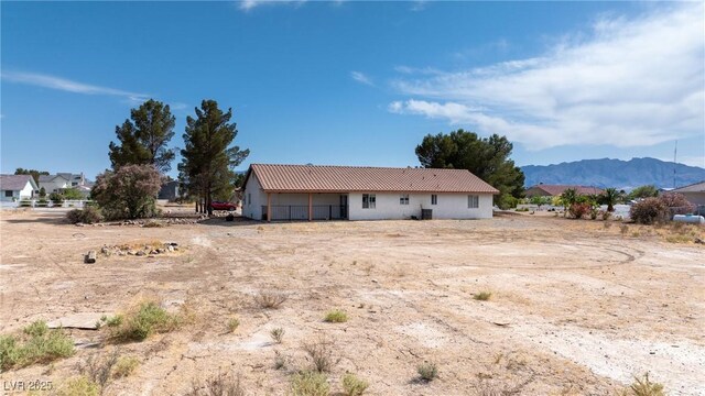 480 China St, Pahrump, NV 89048 - back of property with a tile roof, stucco siding, and a mountain view