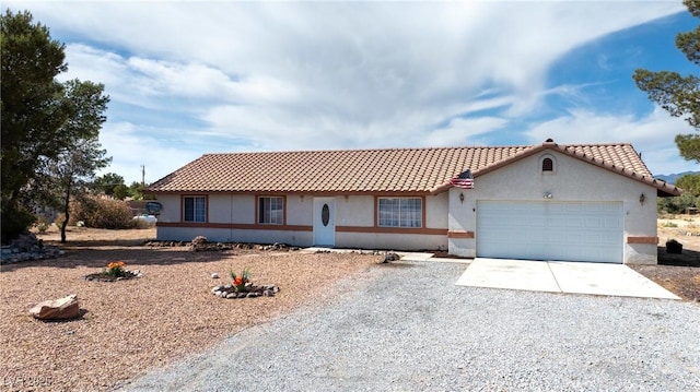 480 China St, Pahrump, NV 89048 - view of front of property featuring driveway, an attached garage, stucco siding, and a tile roof