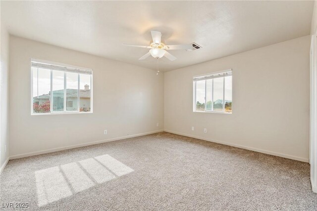 480 China St, Pahrump, NV 89048 - carpeted empty room with plenty of natural light, a ceiling fan, and baseboards
