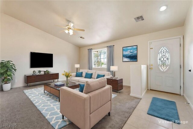 480 China St, Pahrump, NV 89048 - living area with a ceiling fan, vaulted ceiling, baseboards, light colored carpet, and light tile patterned floors