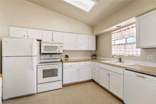 480 China St, Pahrump, NV 89048 - kitchen with white appliances, lofted ceiling, a sink, white cabinets, and light countertops