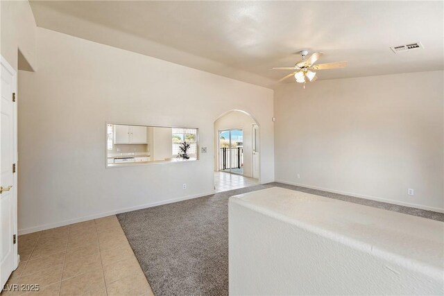 480 China St, Pahrump, NV 89048 - spare room featuring a ceiling fan, arched walkways, light tile patterned floors, and baseboards