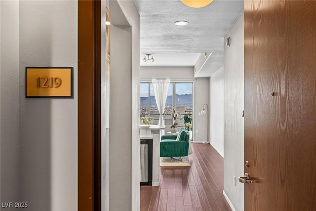 8255 Las Vegas Blvd Unit 1219, Las Vegas, NV 89123 - hall featuring hardwood / wood-style floors, a mountain view, and baseboards