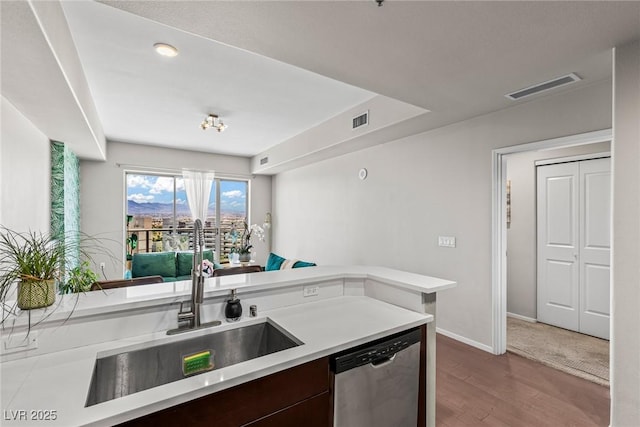 8255 Las Vegas Blvd Unit 1219, Las Vegas, NV 89123 - kitchen featuring stainless steel dishwasher, a sink, light countertops, wood finished floors, and baseboards
