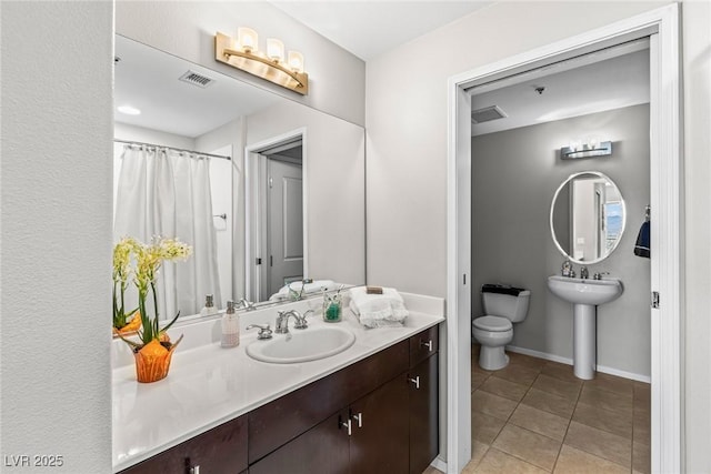 8255 Las Vegas Blvd Unit 1219, Las Vegas, NV 89123 - full bath with toilet, a sink, tile patterned floors, and baseboards