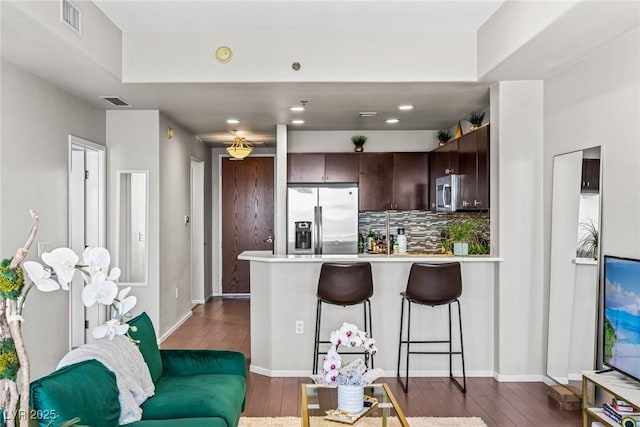 8255 Las Vegas Blvd Unit 1219, Las Vegas, NV 89123 - kitchen with appliances with stainless steel finishes, a peninsula, dark brown cabinetry, light countertops, and recessed lighting