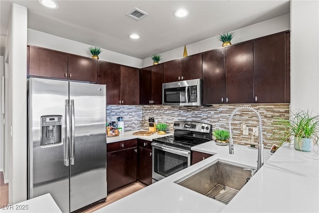 8255 Las Vegas Blvd Unit 1219, Las Vegas, NV 89123 - kitchen with stainless steel appliances, a sink, light countertops, tasteful backsplash, and recessed lighting