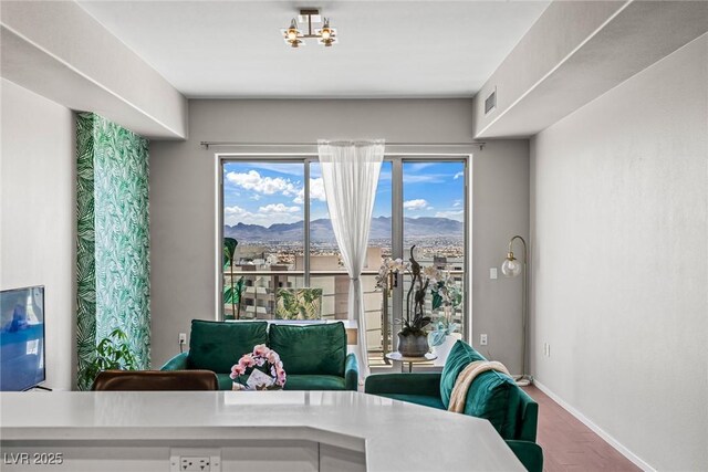 8255 Las Vegas Blvd Unit 1219, Las Vegas, NV 89123 - dining area with baseboards, a mountain view, wood finished floors, and a chandelier