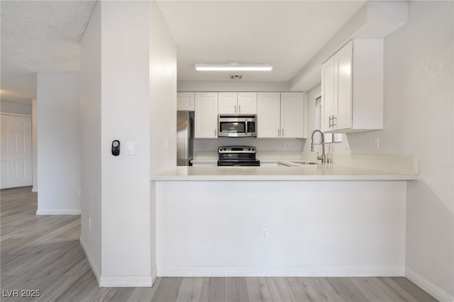 6871 Tamarus St Unit 204, Las Vegas, NV 89119 - kitchen featuring appliances with stainless steel finishes, a sink, baseboards, and light countertops