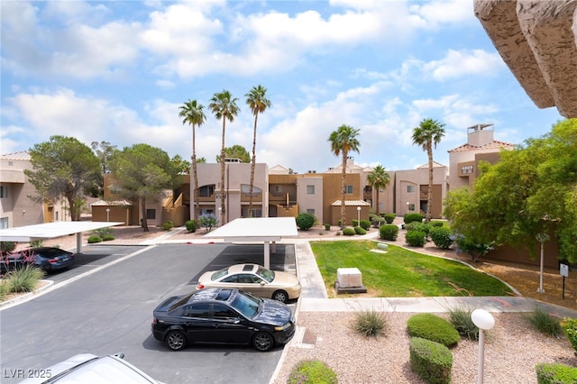 6871 Tamarus St Unit 204, Las Vegas, NV 89119 - view of building exterior featuring covered and uncovered parking and a residential view