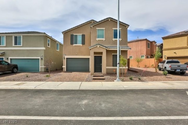 6207 Hamilton Ave, Las Vegas, NV 89122 - view of front facade featuring a garage, stucco siding, and decorative driveway