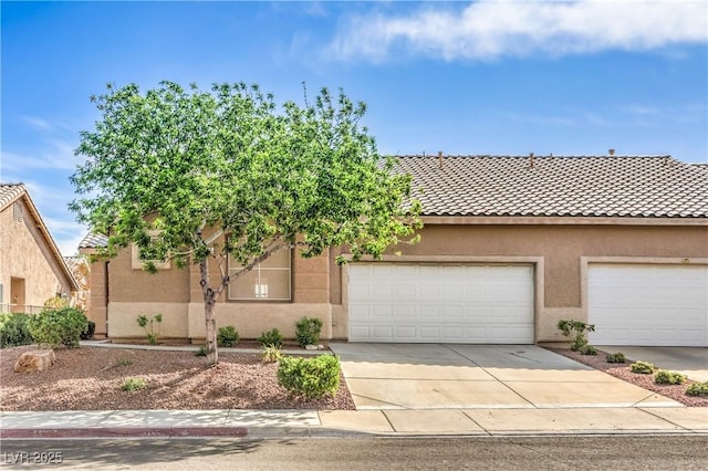 202 Twin Creek St, Henderson, NV 89074 - view of front facade featuring stucco siding, driveway, a tiled roof, and an attached garage