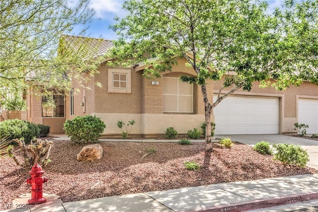 202 Twin Creek St, Henderson, NV 89074 - obstructed view of property featuring stucco siding, driveway, and a garage