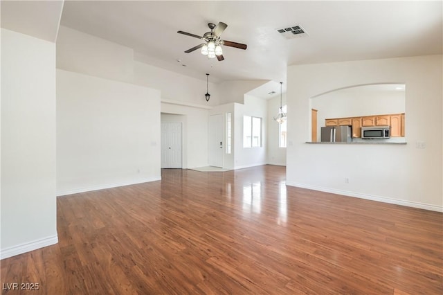 202 Twin Creek St, Henderson, NV 89074 - unfurnished living room featuring a ceiling fan, wood finished floors, vaulted ceiling, and baseboards