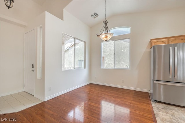 202 Twin Creek St, Henderson, NV 89074 - unfurnished dining area featuring light wood-style floors, plenty of natural light, lofted ceiling, and baseboards