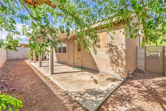 202 Twin Creek St, Henderson, NV 89074 - rear view of house with stucco siding, a fenced backyard, and a patio area